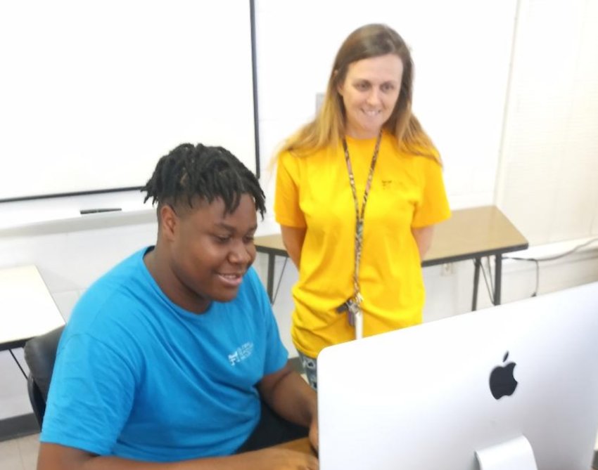 Philadelphia High School’s Zavien Spencer reviews a problem with his AP computer teacher Deana Cumberland.